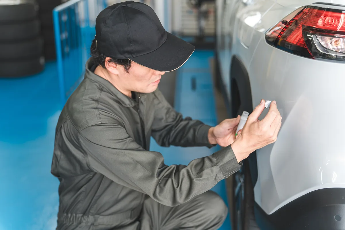 車のキズを補修する整備士